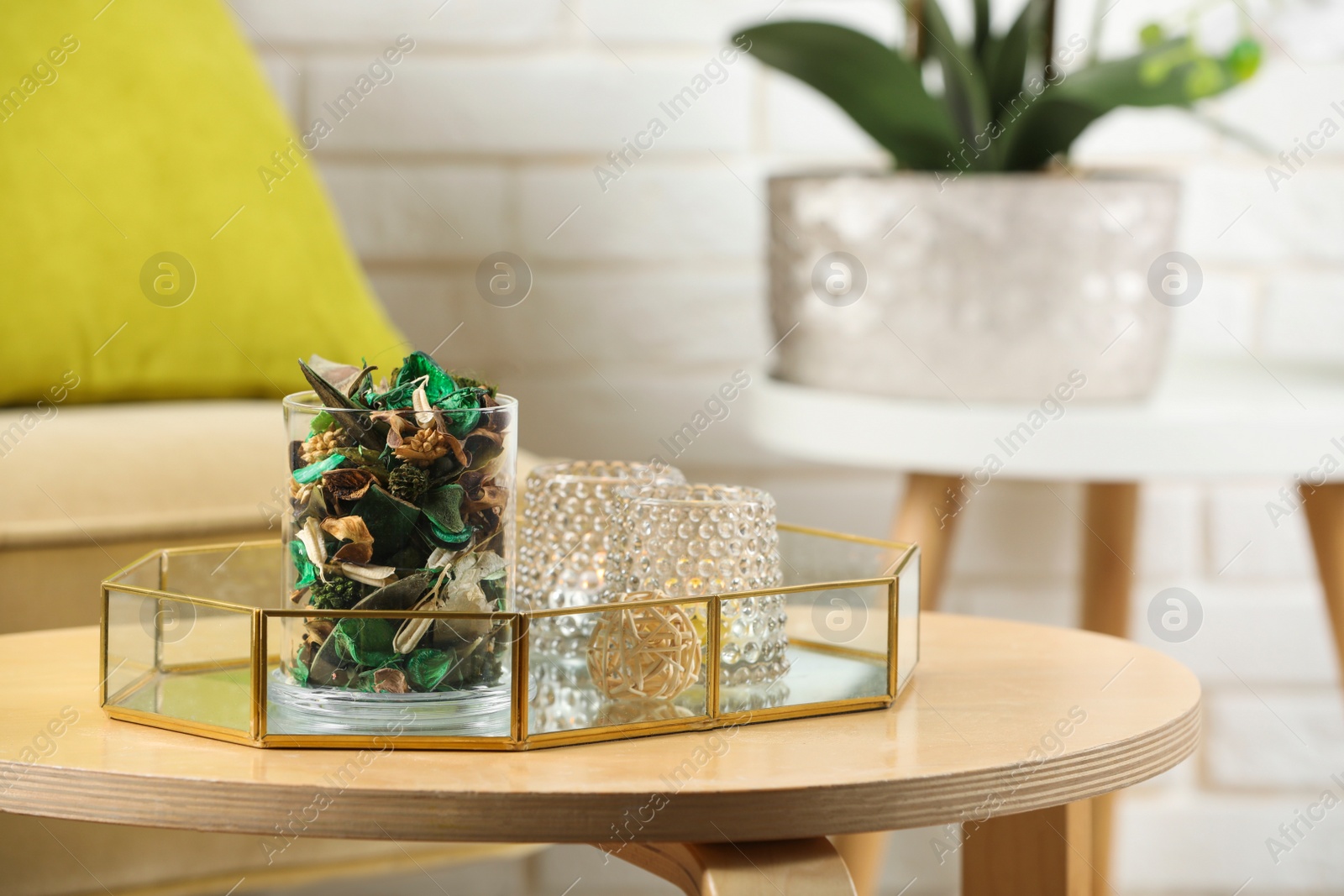 Photo of Glass jar with aromatic potpourri of dried flowers and different decor element on wooden table indoors. Space for text