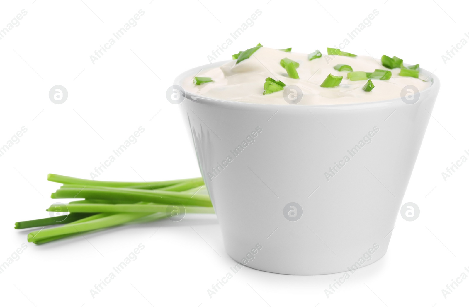 Photo of Fresh sour cream with onion on white background