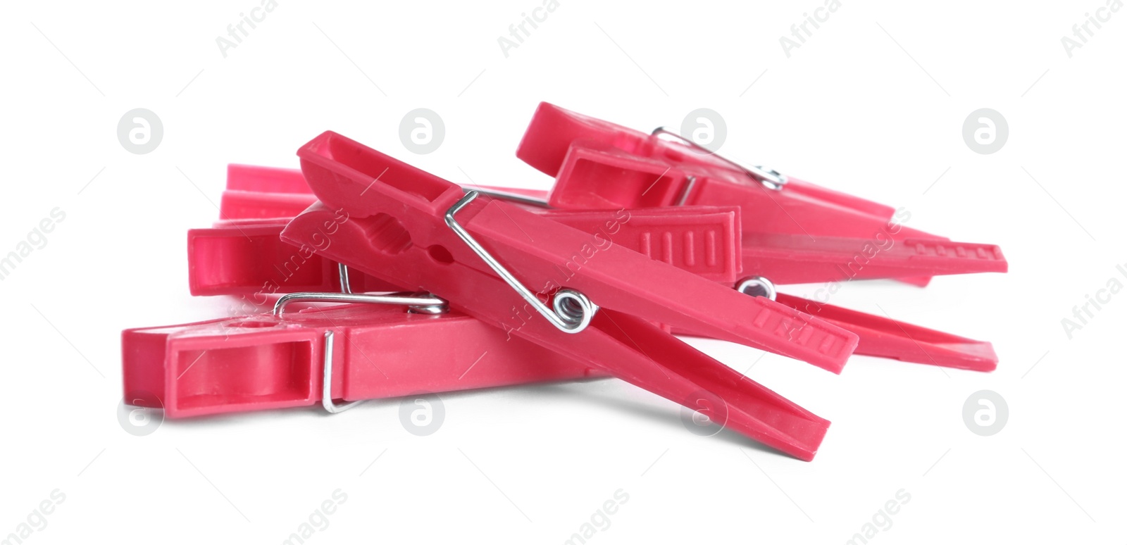 Photo of Bright pink plastic clothespins on white background