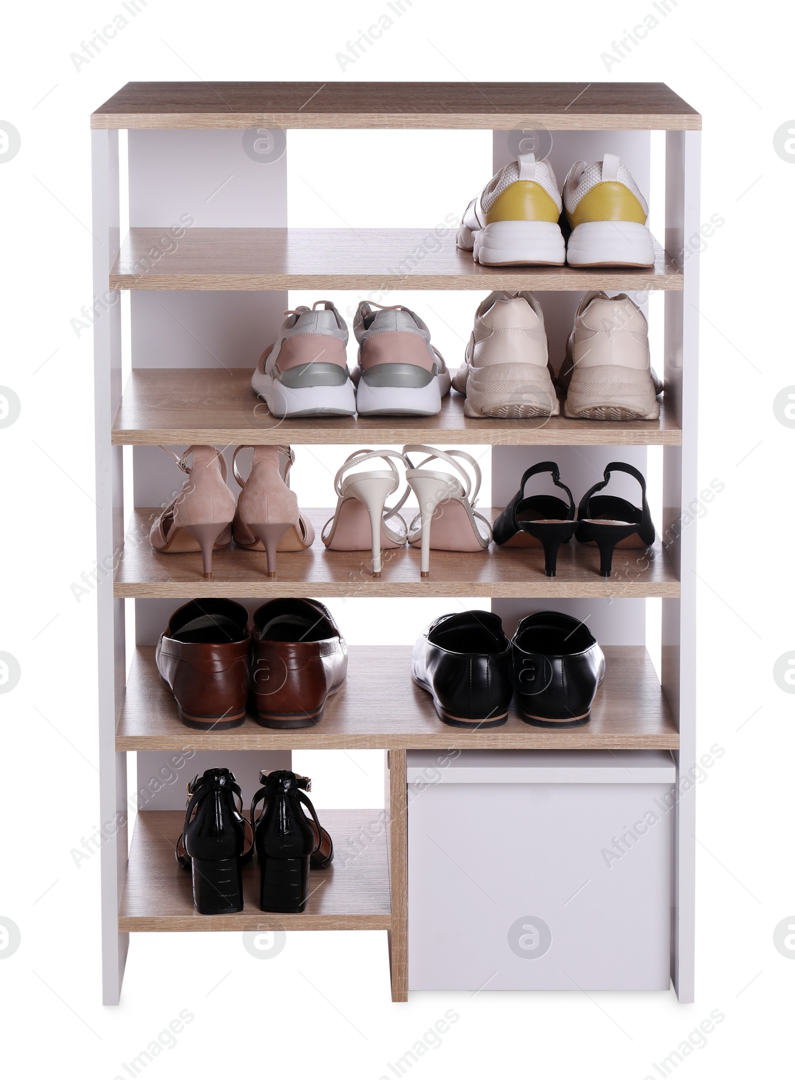 Photo of Stylish shelving unit with different pairs of shoes on white background. Storage idea