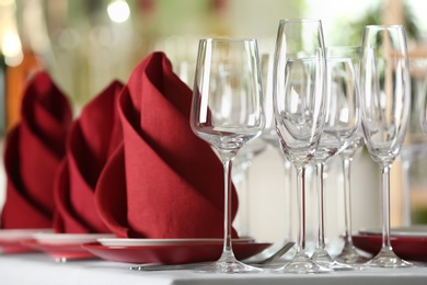 Photo of Table setting with empty glasses, plates and cutlery on table