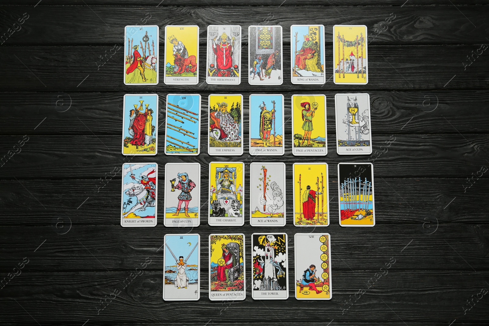 Photo of Tarot cards on black wooden table, flat lay