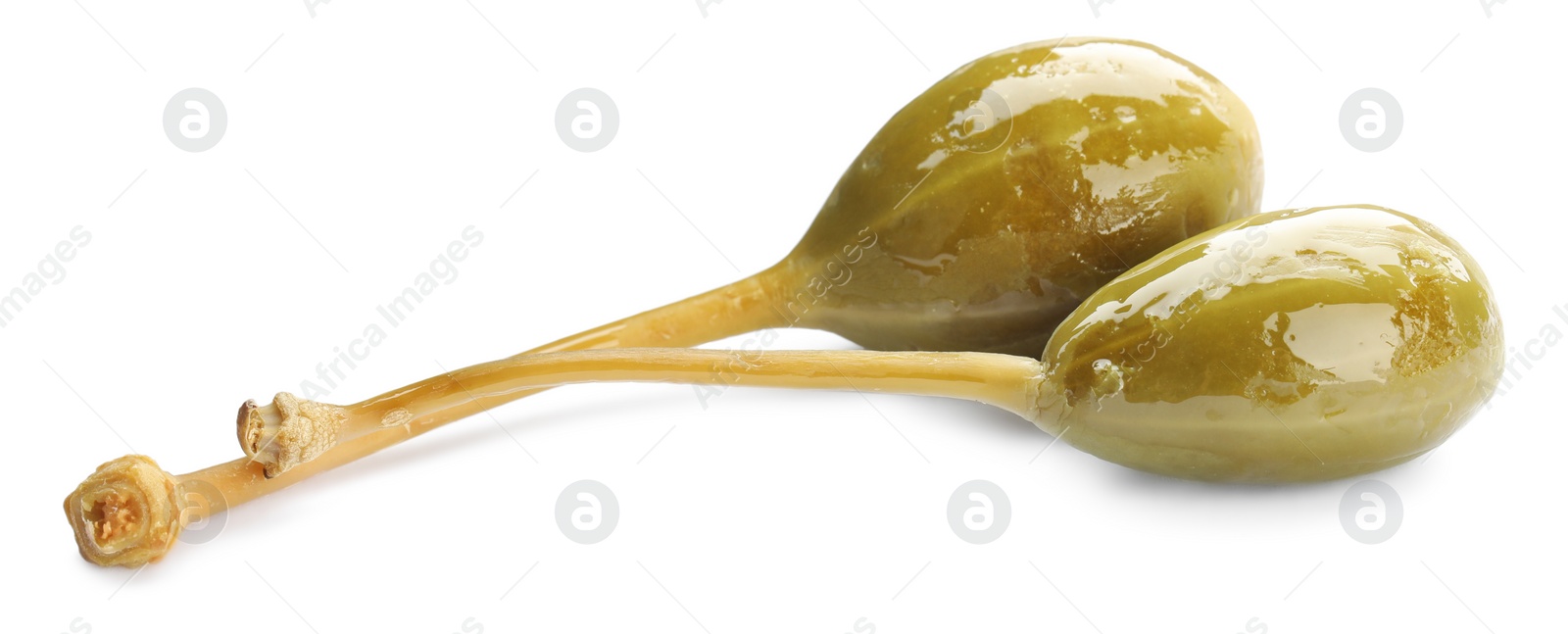 Photo of Two delicious pickled capers on white background