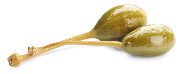 Photo of Two delicious pickled capers on white background