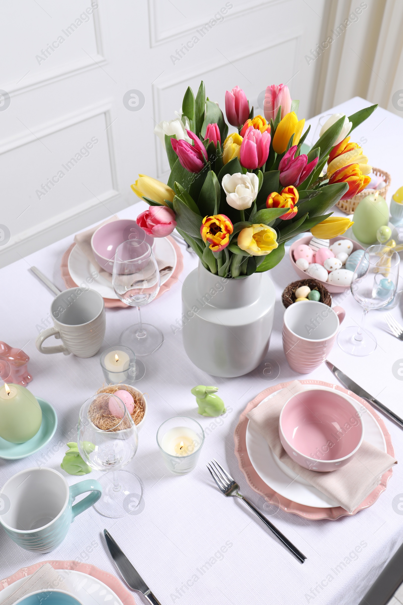 Photo of Festive table setting with beautiful flowers. Easter celebration