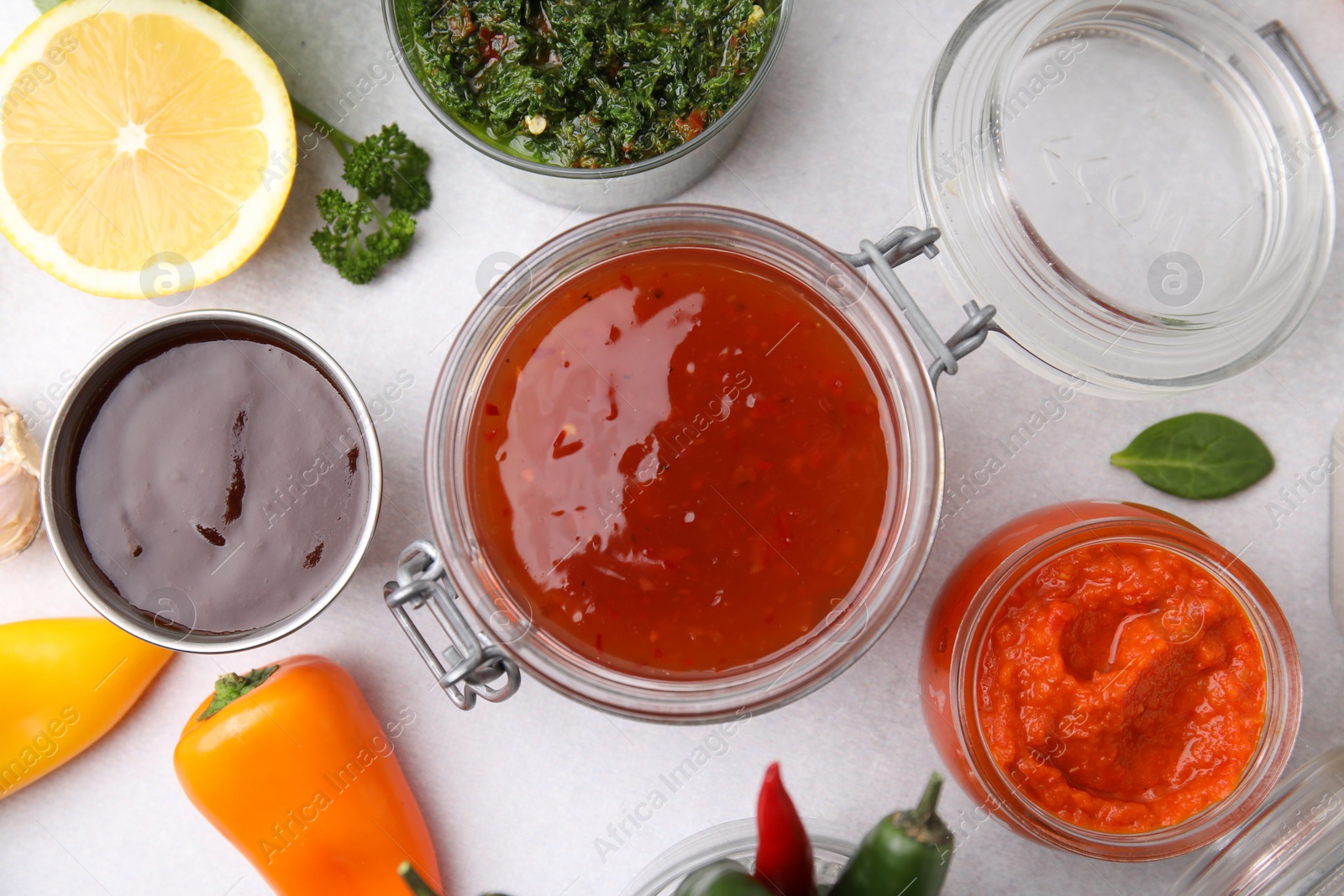 Photo of Different marinades and products on light table, flat lay