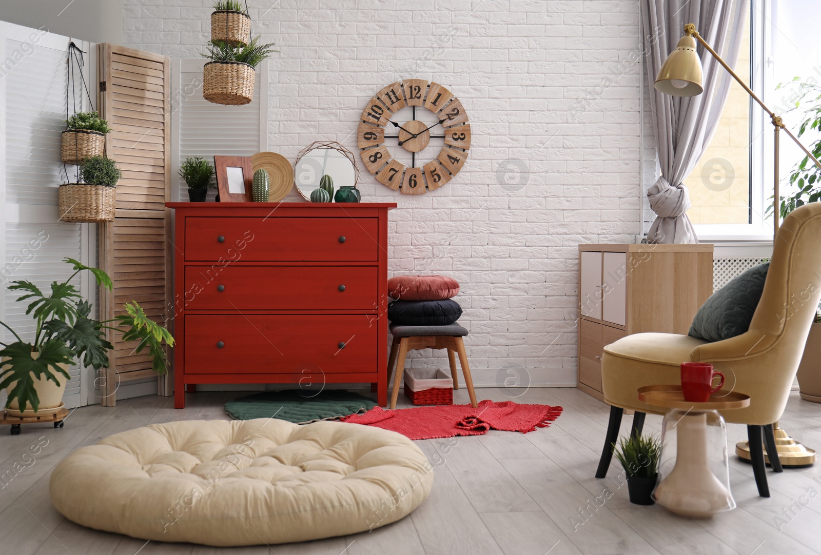 Photo of Stylish room interior with chest of drawers and pet bed