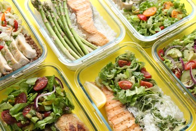 Photo of Healthy food. Different meals in glass containers on yellow background, above view