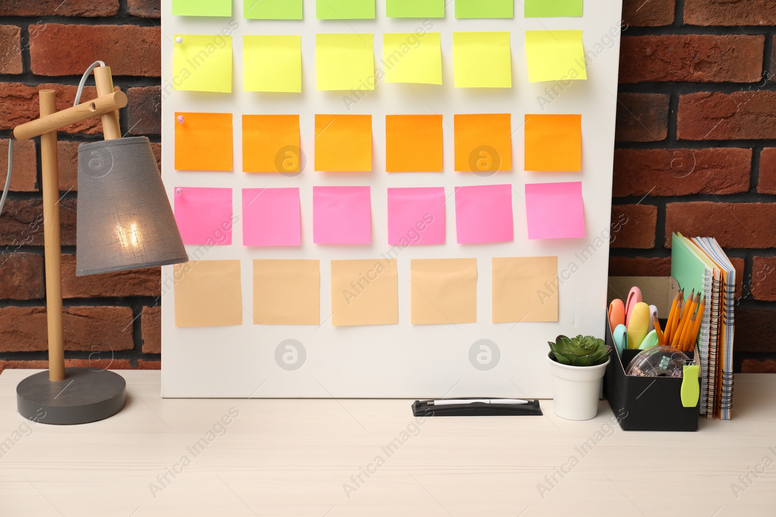 Photo of Business process planning and optimization. Workplace with colorful paper notes and other stationery on table