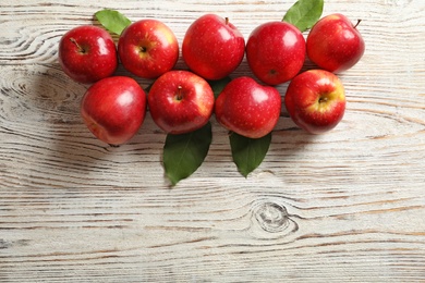 Photo of Fresh ripe red apples on wooden background