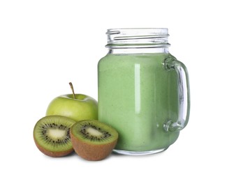 Photo of Tasty fresh green smoothie in mason jar near ingredients on white background
