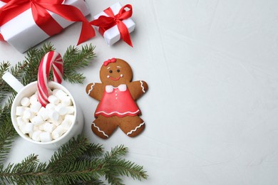 Photo of Flat lay composition with gingerbread girl on light  grey table. Space for text