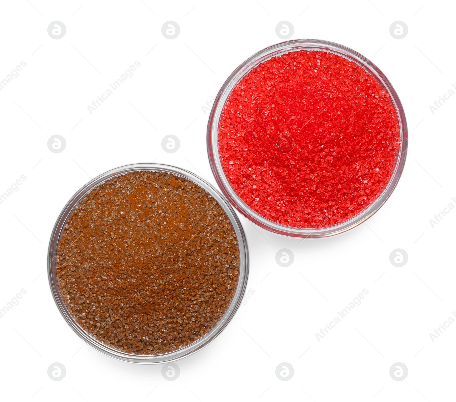 Photo of Glass bowls with brown and red food coloring isolated on white, top view