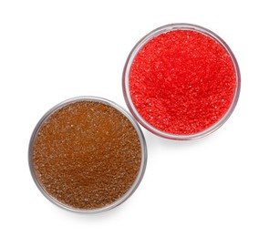 Photo of Glass bowls with brown and red food coloring isolated on white, top view