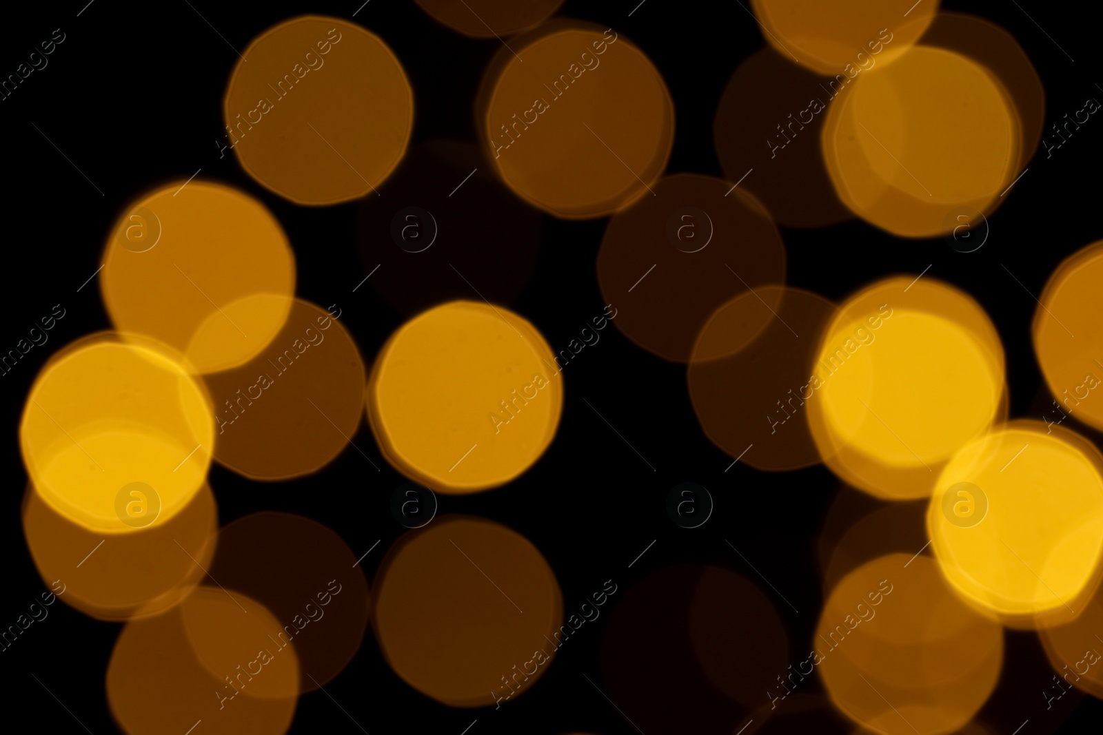 Photo of Blurred view of beautiful lights on black background. Bokeh effect