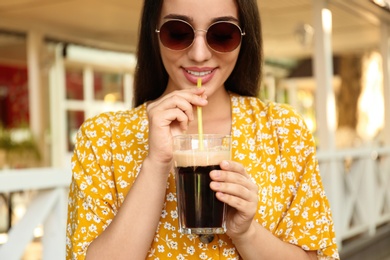 Beautiful woman with cold kvass outdoors. Traditional Russian summer drink