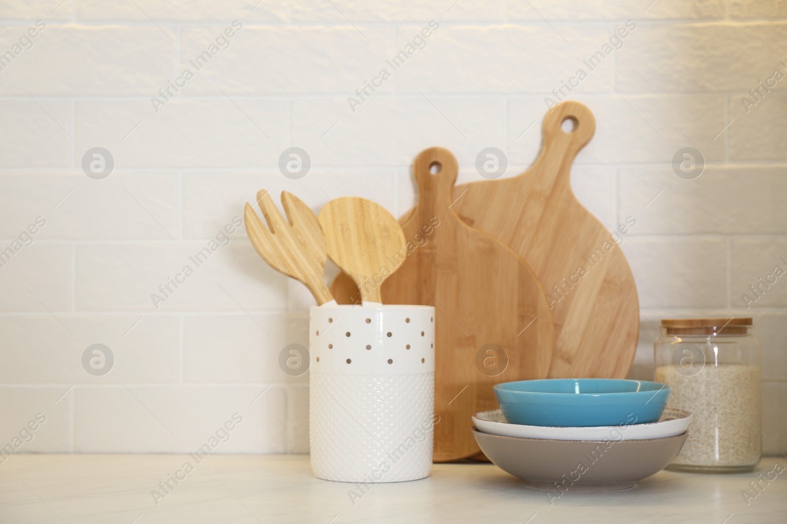 Photo of Wooden boards and different kitchen items on countertop indoors
