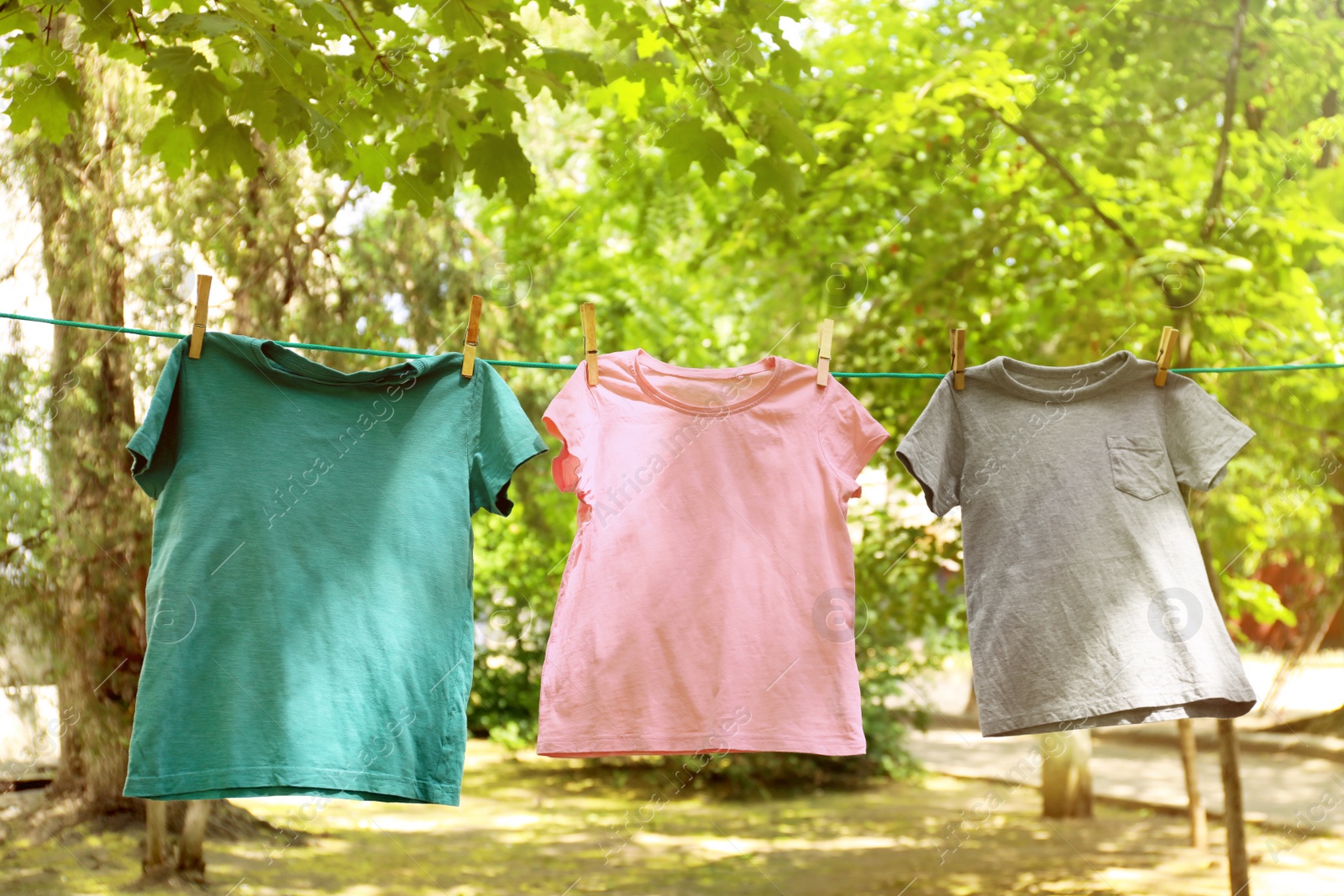 Photo of Laundry line with clothes outdoors on sunny day