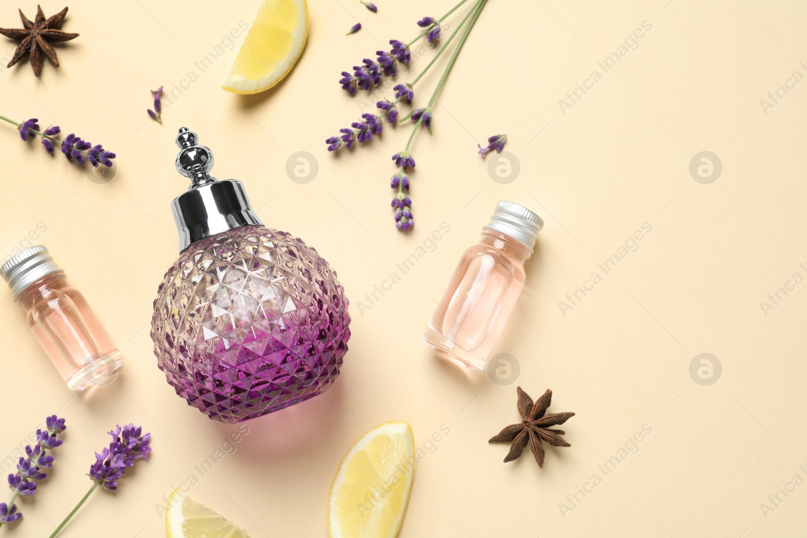 Photo of Flat lay composition with elegant perfume on beige background, space for text