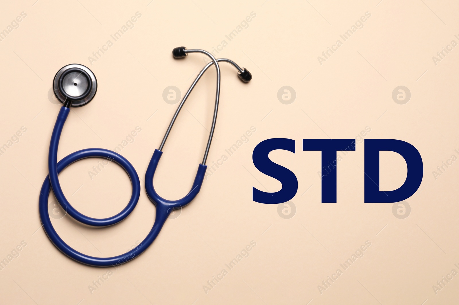 Image of Text STD and stethoscope on beige background, top view