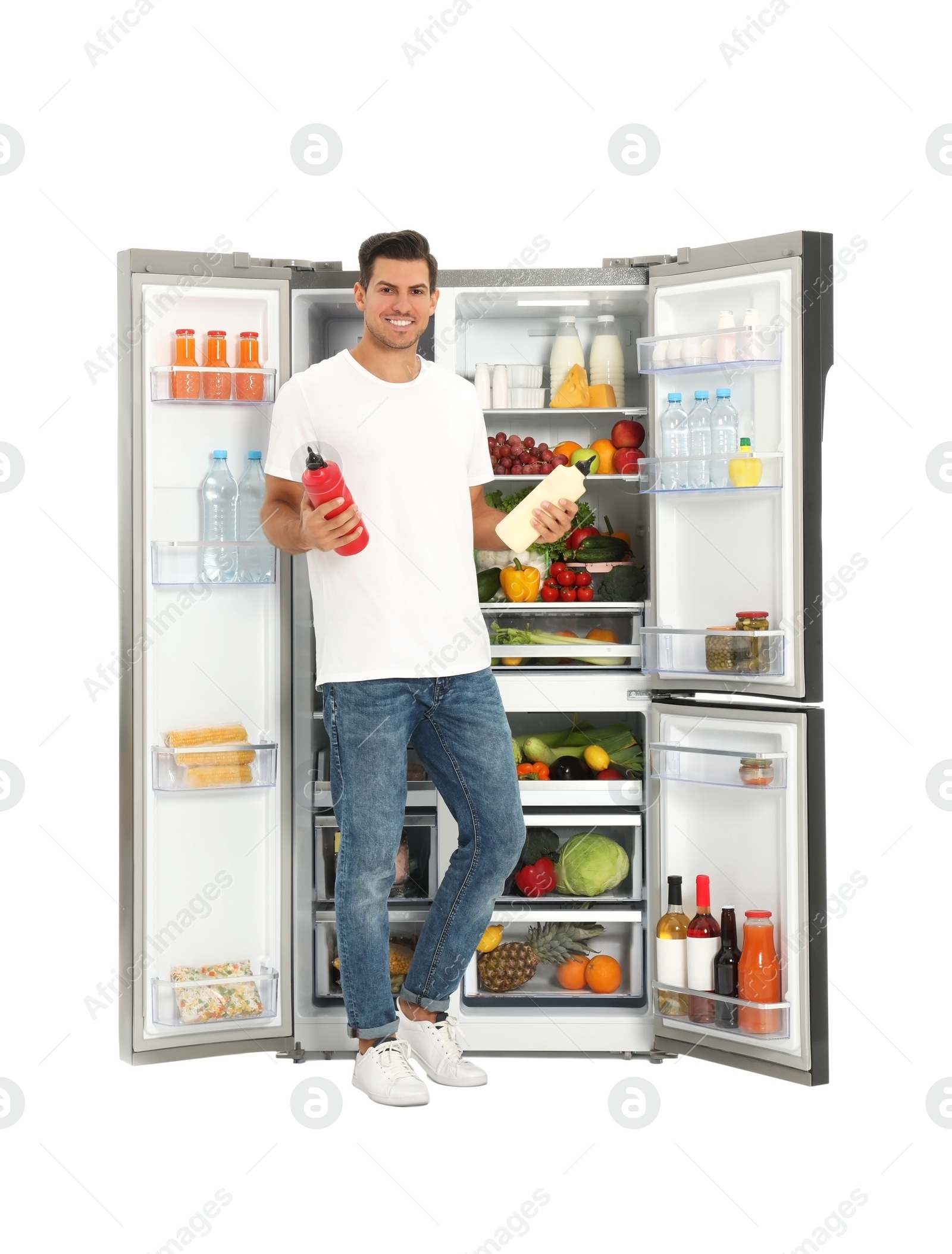 Photo of Man with sauces near open refrigerator on white background