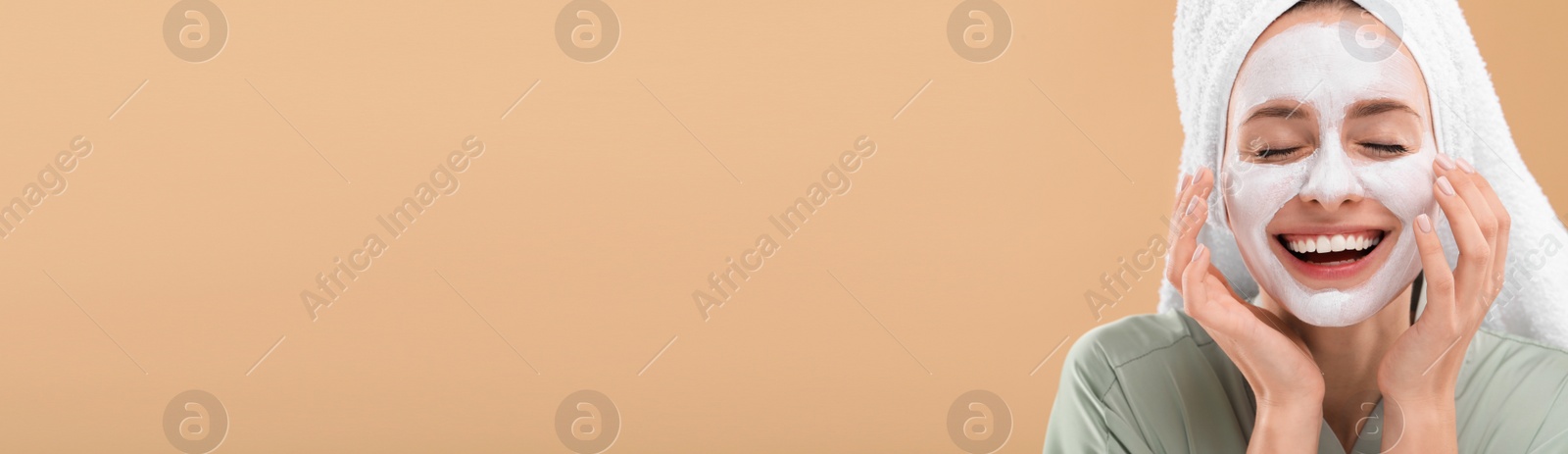 Image of Spa treatment. Happy woman with face mask on pale orange background. Banner design with space for text