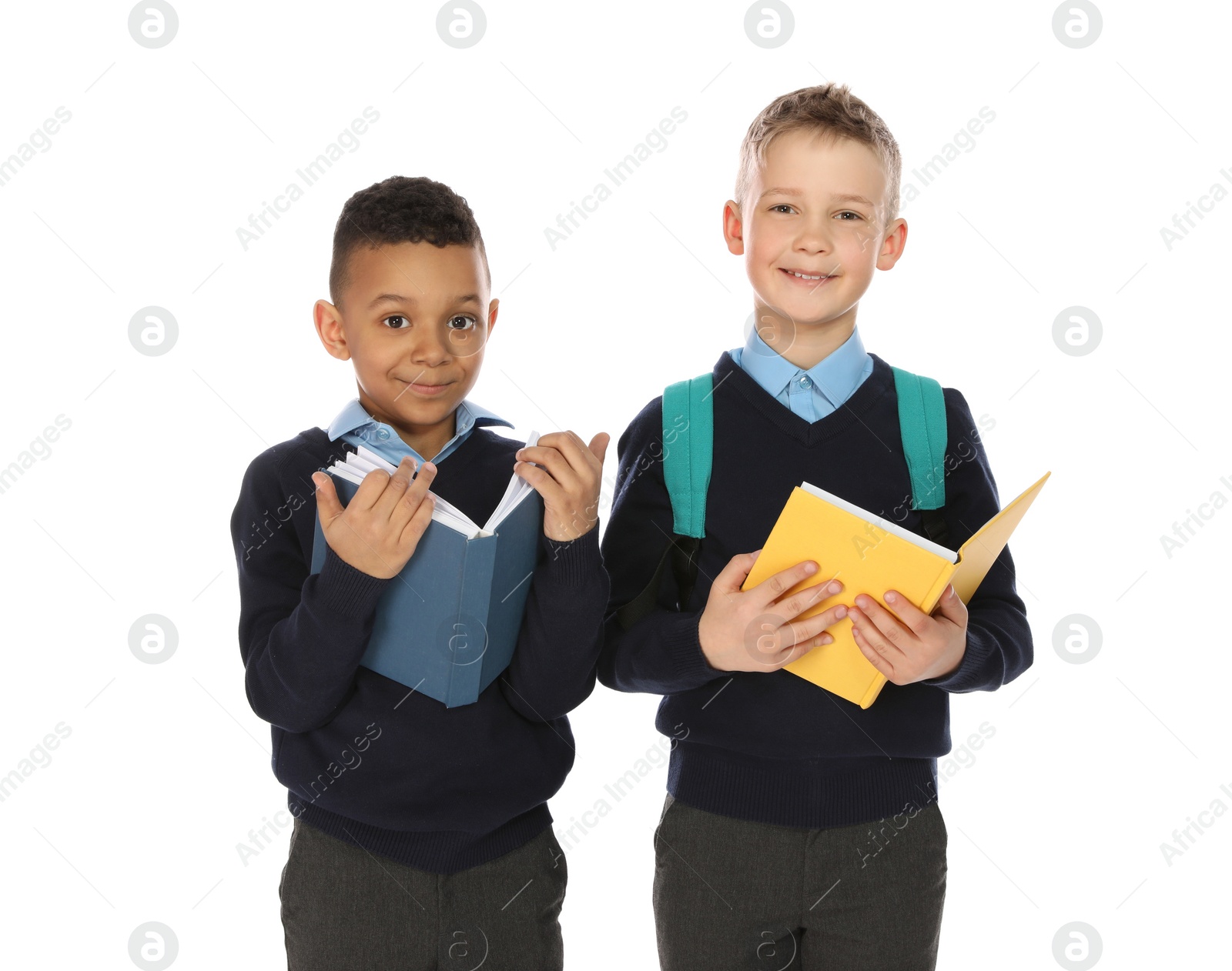 Photo of Portrait of cute children in school uniform with books on white background