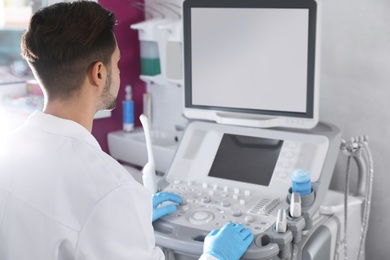 Photo of Sonographer using modern ultrasound machine in clinic