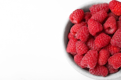 Top view of bowl with delicious ripe raspberries on white background, closeup