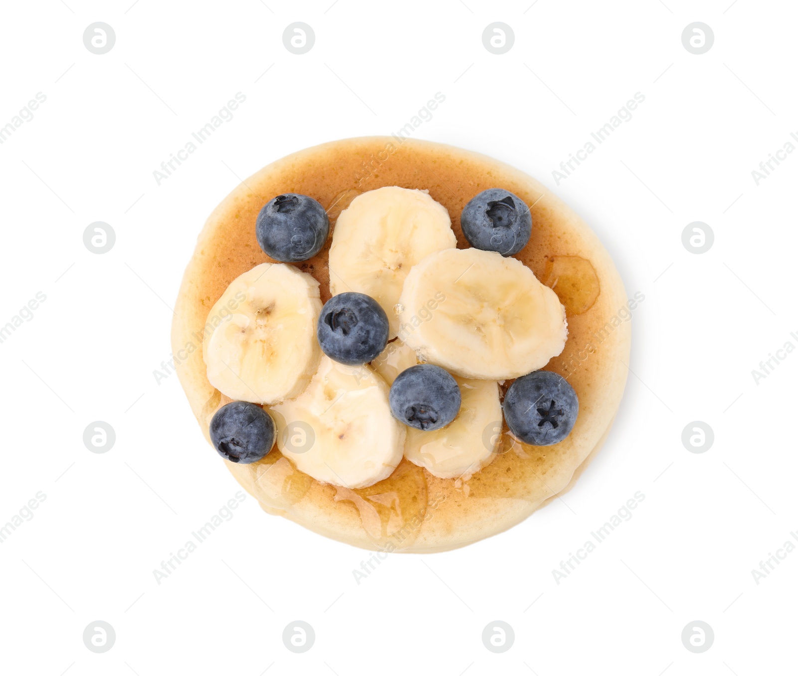 Photo of Delicious pancake with banana slices, blueberries and honey isolated on white, top view