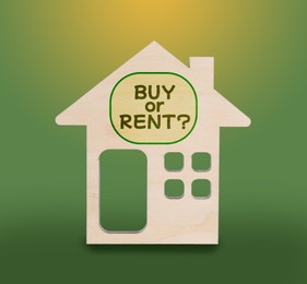 Model of house with words Buy Or Rent on yellow green background