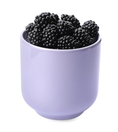 Photo of Purple cup of tasty blackberries on white background