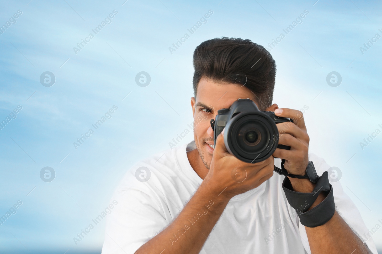 Photo of Photographer taking picture with professional camera outdoors