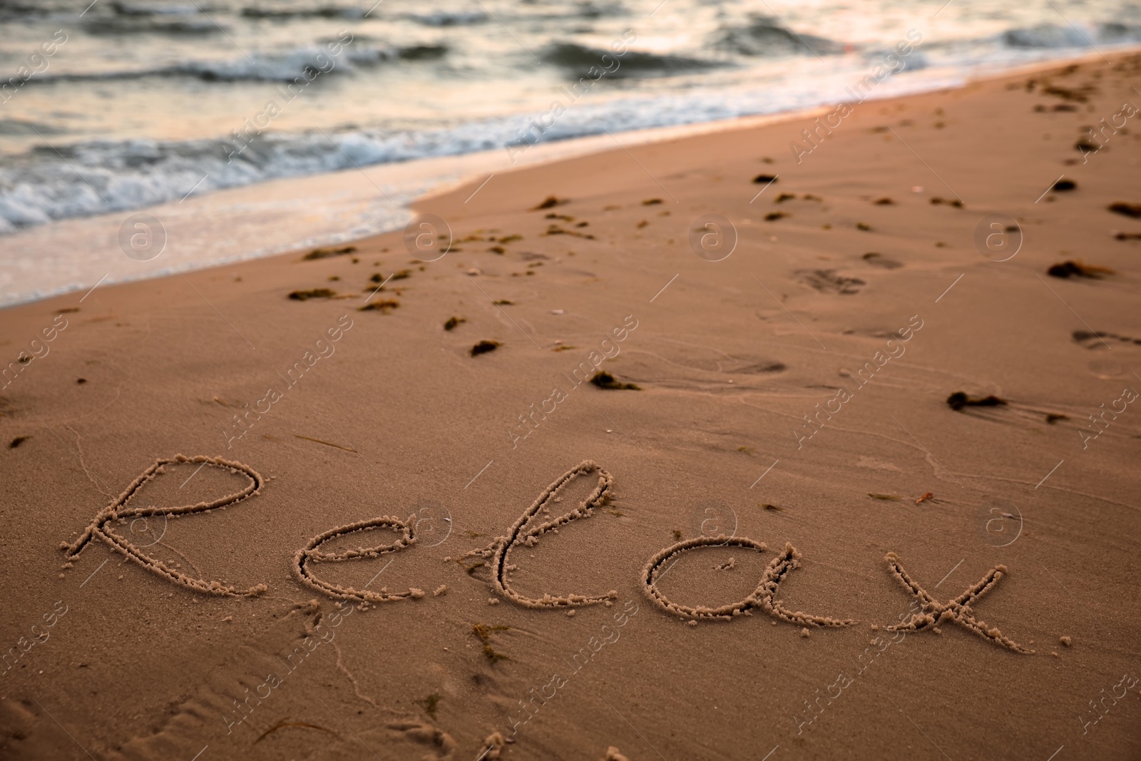 Photo of Sandy beach with written word Relax in summer