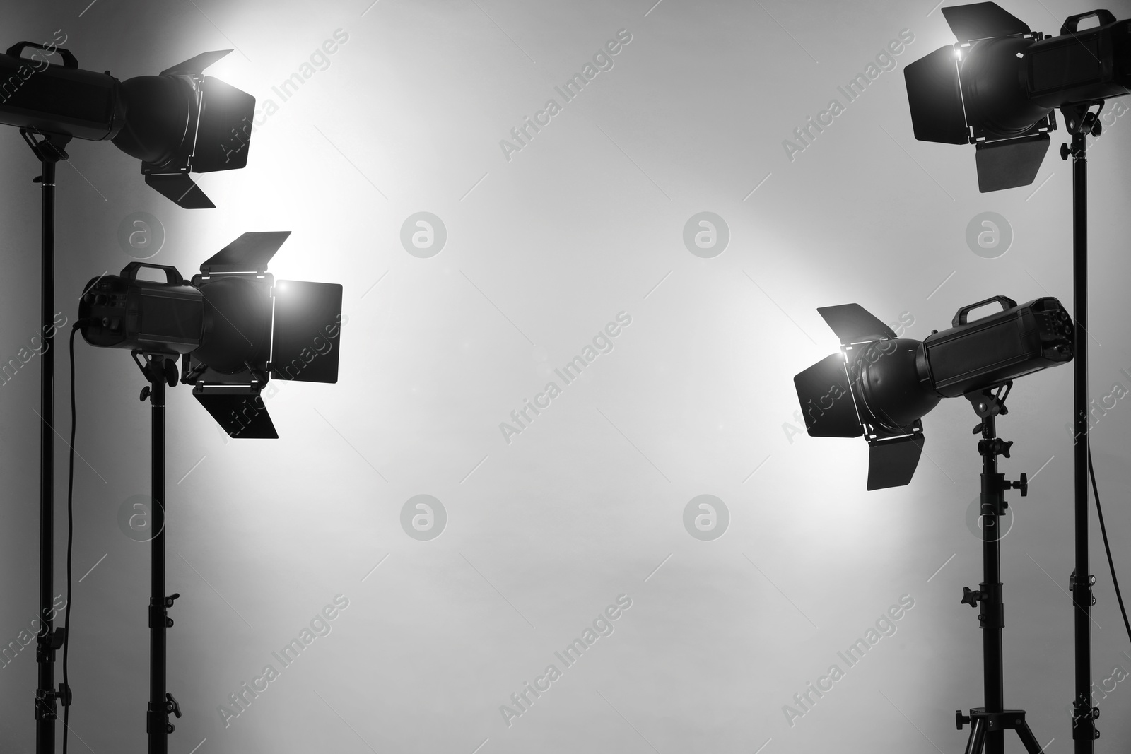 Photo of Grey photo background and professional lighting equipment in studio