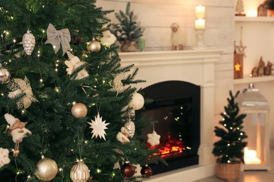 Stylish living room interior with decorated Christmas tree and fireplace