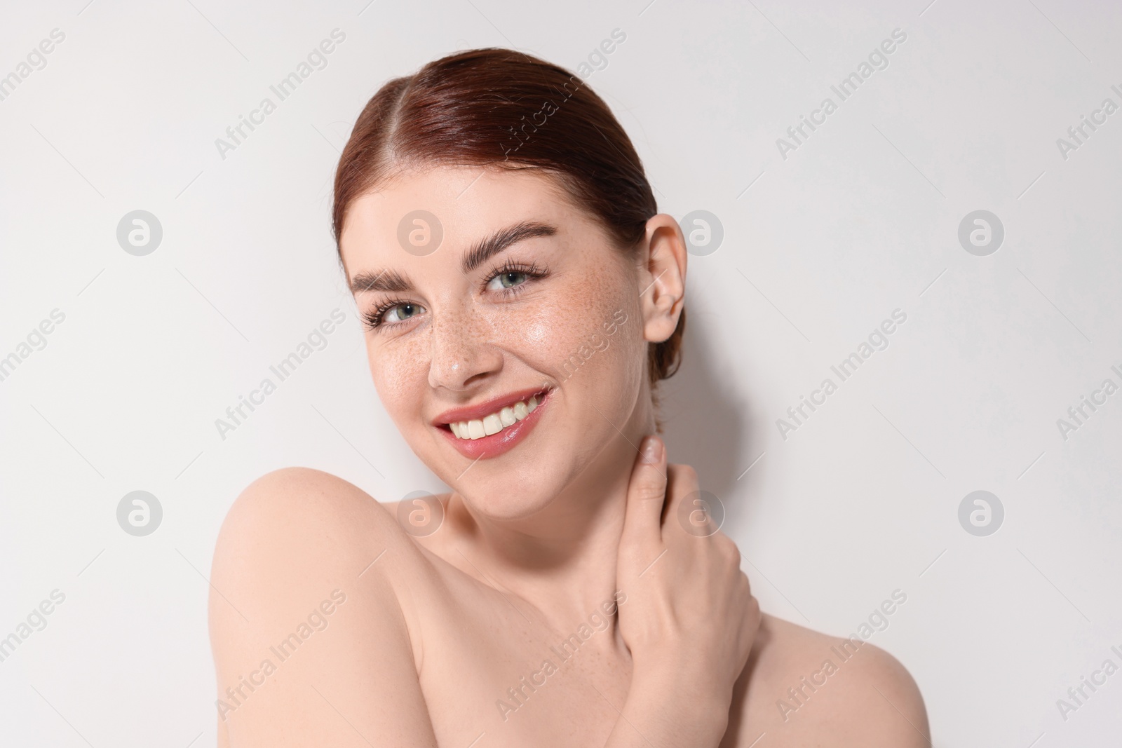 Photo of Portrait of smiling woman on light background