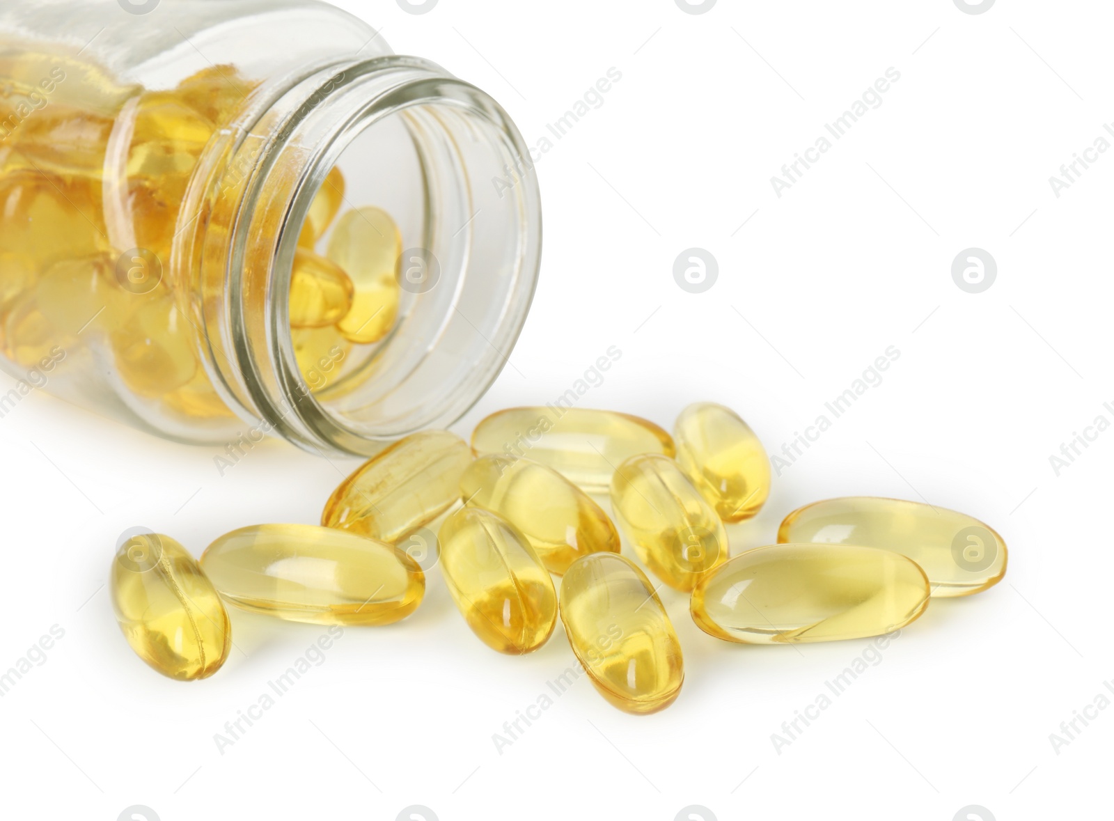 Photo of Scattered softgel capsules and bottle isolated on white