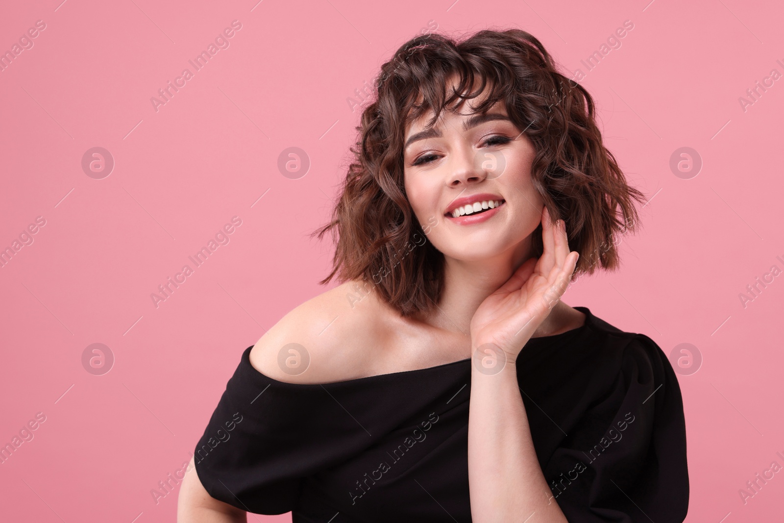 Photo of Portrait of beautiful young woman with wavy hairstyle on pink background. Space for text