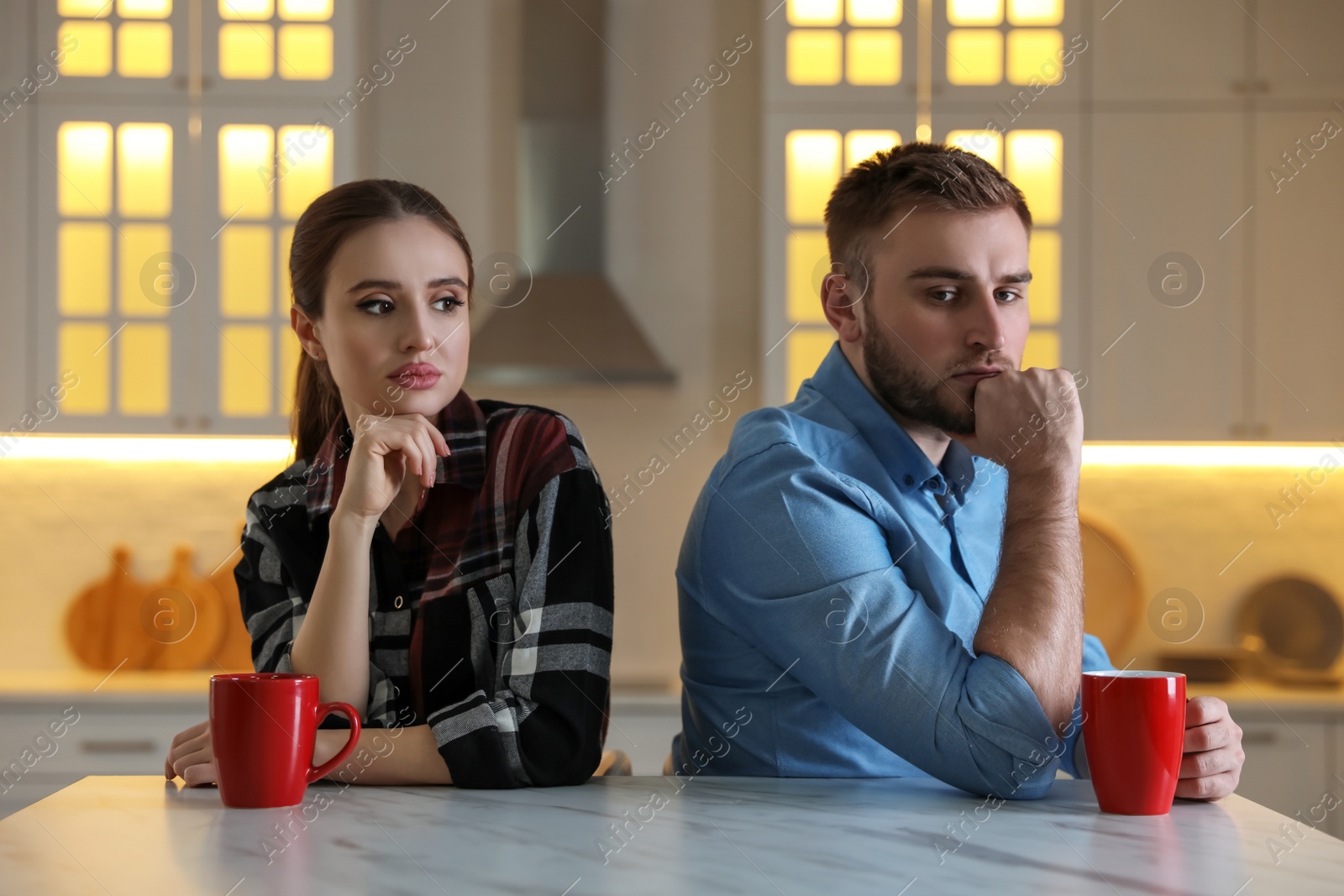 Photo of Young couple quarreling at home. Jealousy in relationship