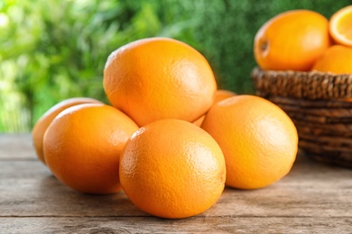 Photo of Fresh juicy oranges on wooden table. Healthy fruits