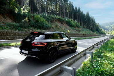 Photo of Picturesque view of asphalt road with modern car