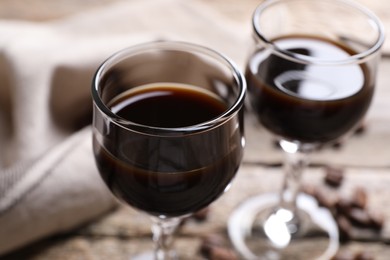 Photo of Glasses of coffee liqueur on table, closeup