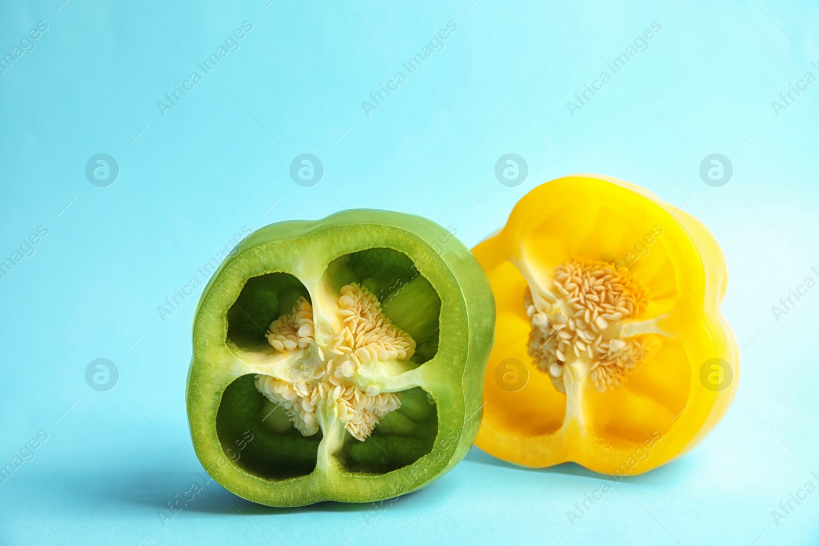 Photo of Cut ripe paprika peppers on color background