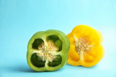 Cut ripe paprika peppers on color background