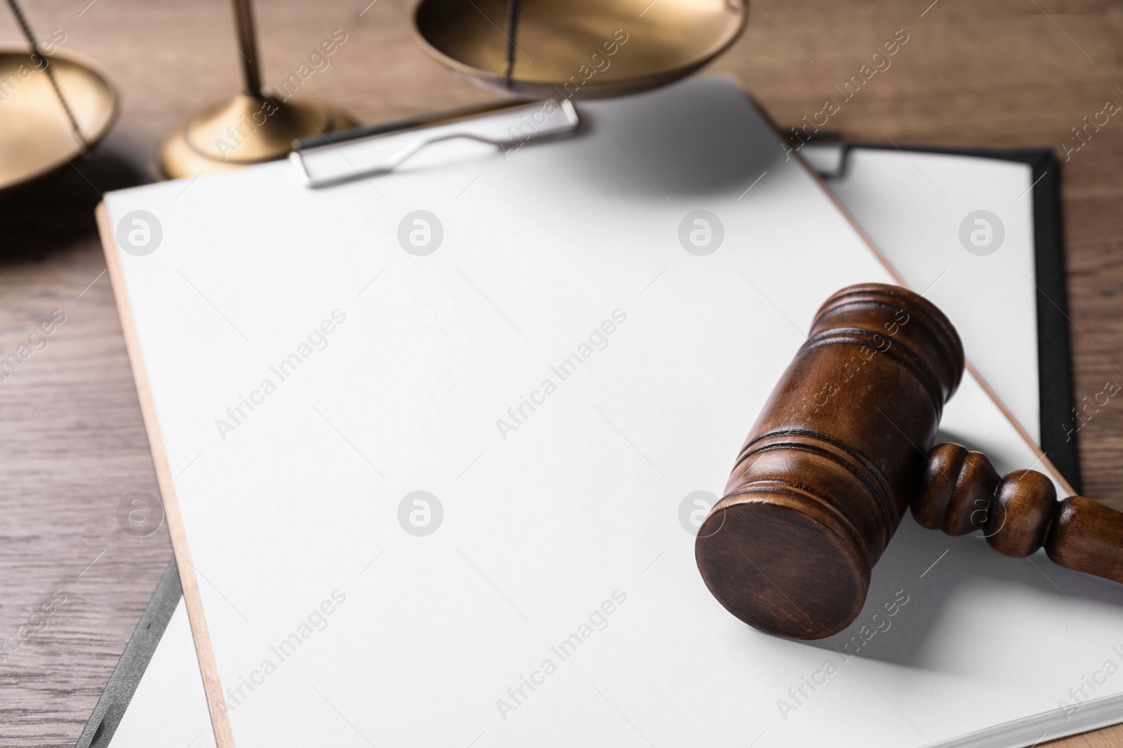 Photo of Clipboard with words DOMESTIC VIOLENCE and gavel on wooden table