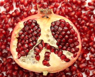 Ripe juicy red pomegranate on grains grains, top view