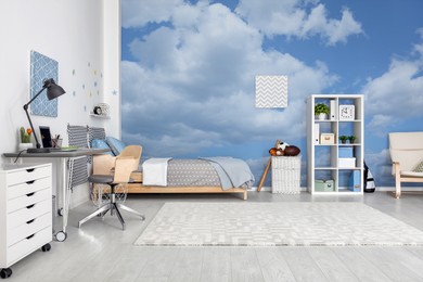 Image of Pattern of blue sky with clouds on wallpaper in furnished room. Beautiful interior design