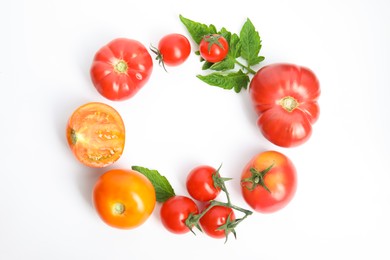 Photo of Frame of different ripe tomatoes and leaves on white background, flat lay. Space for text