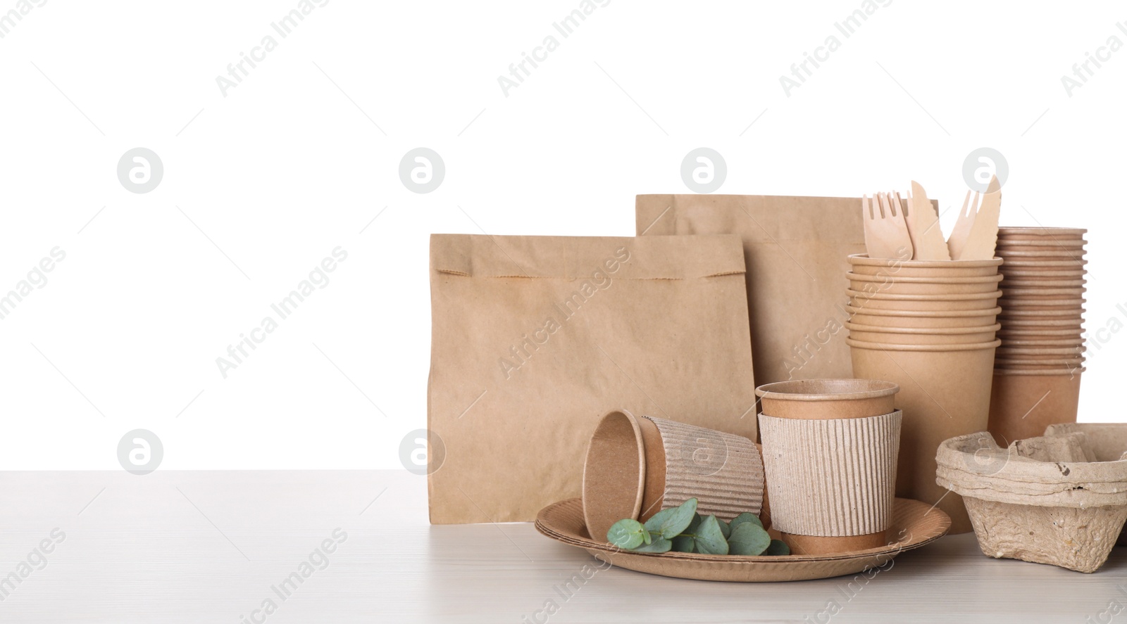 Photo of Set of disposable eco friendly dishware on white background